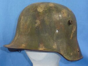 Camouflage Battle Damaged M1916 German WWI Combat Helmet by Eisenhuttenwerk